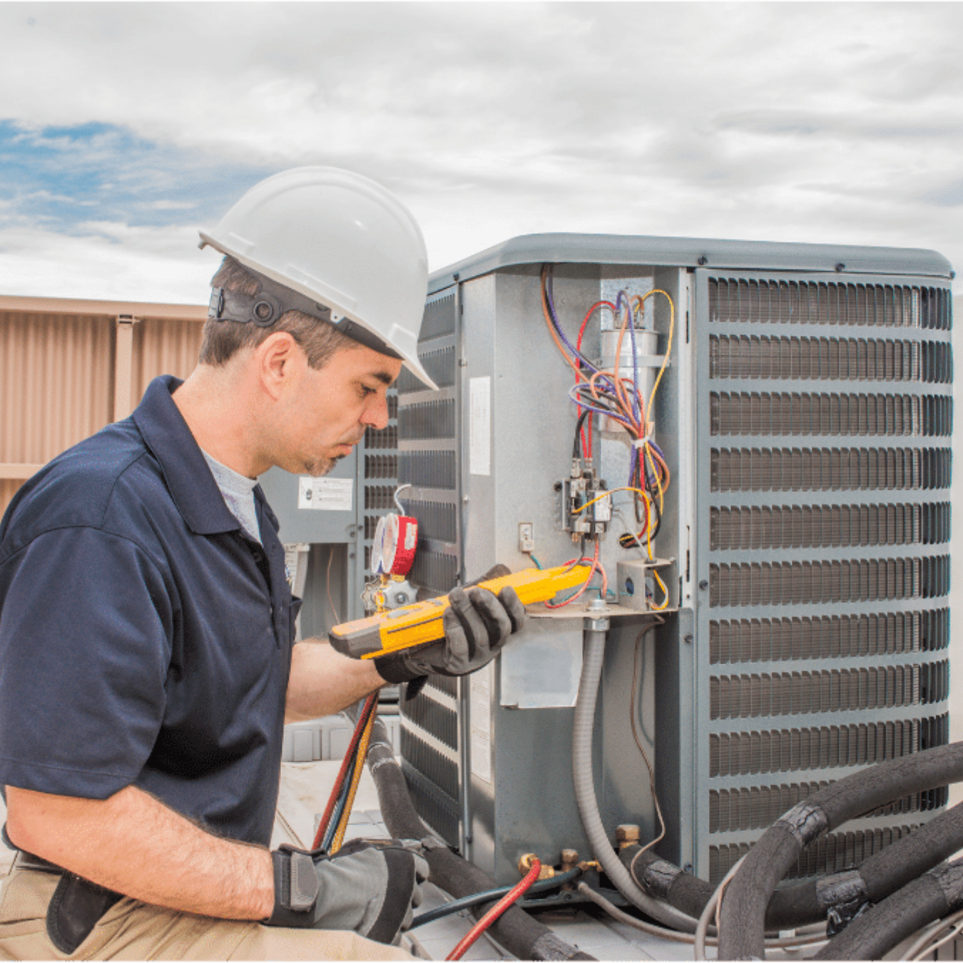 Norfolk Heating & Cooling HVAC technician servicing a system